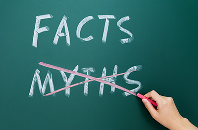 Hand drawing myths and facts on blackboard.