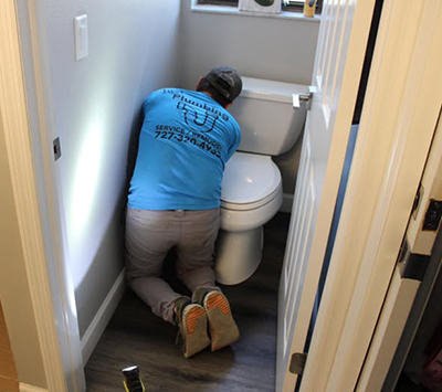 man fixing toilet